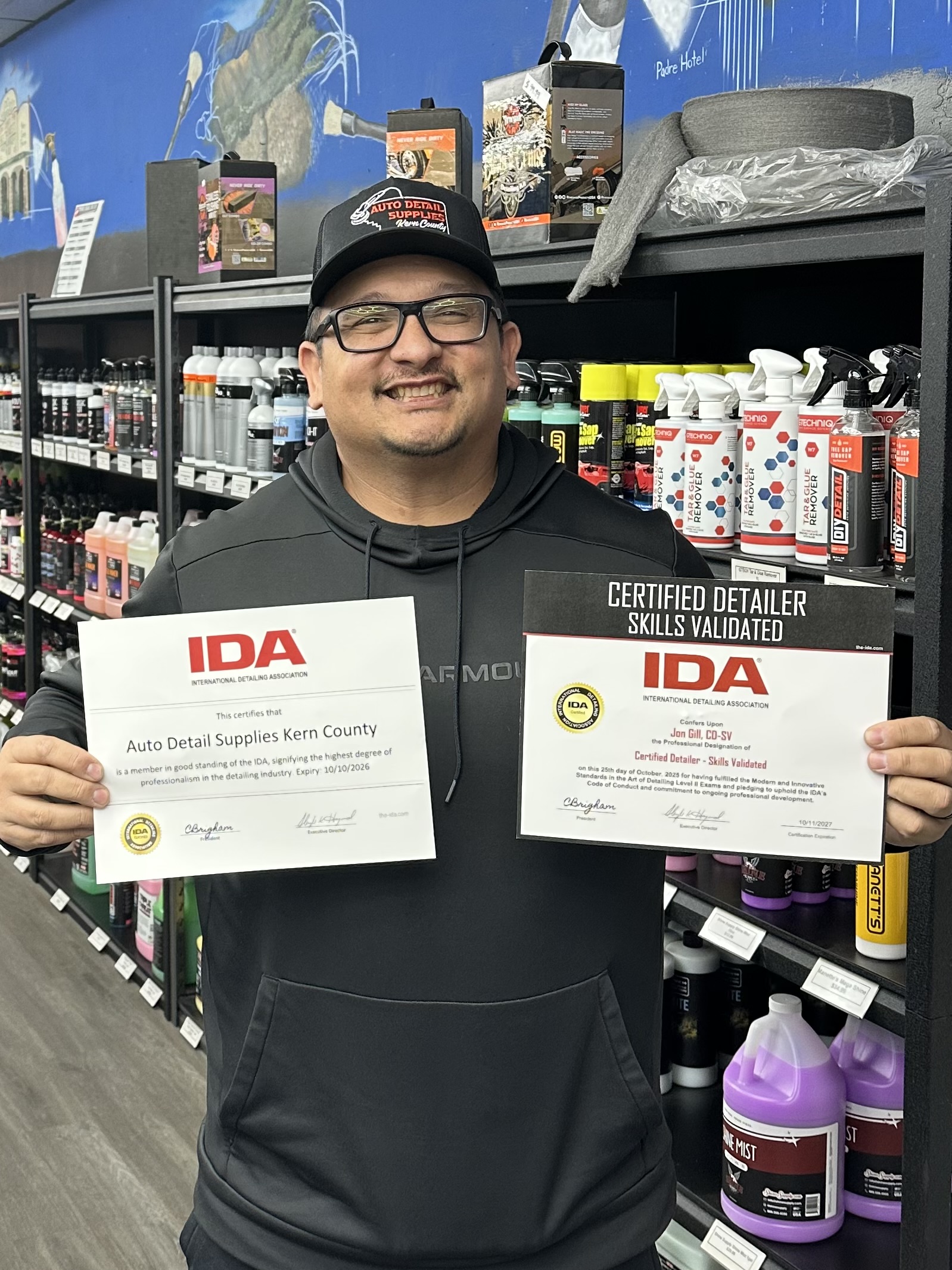 Owner holding detailing certifications