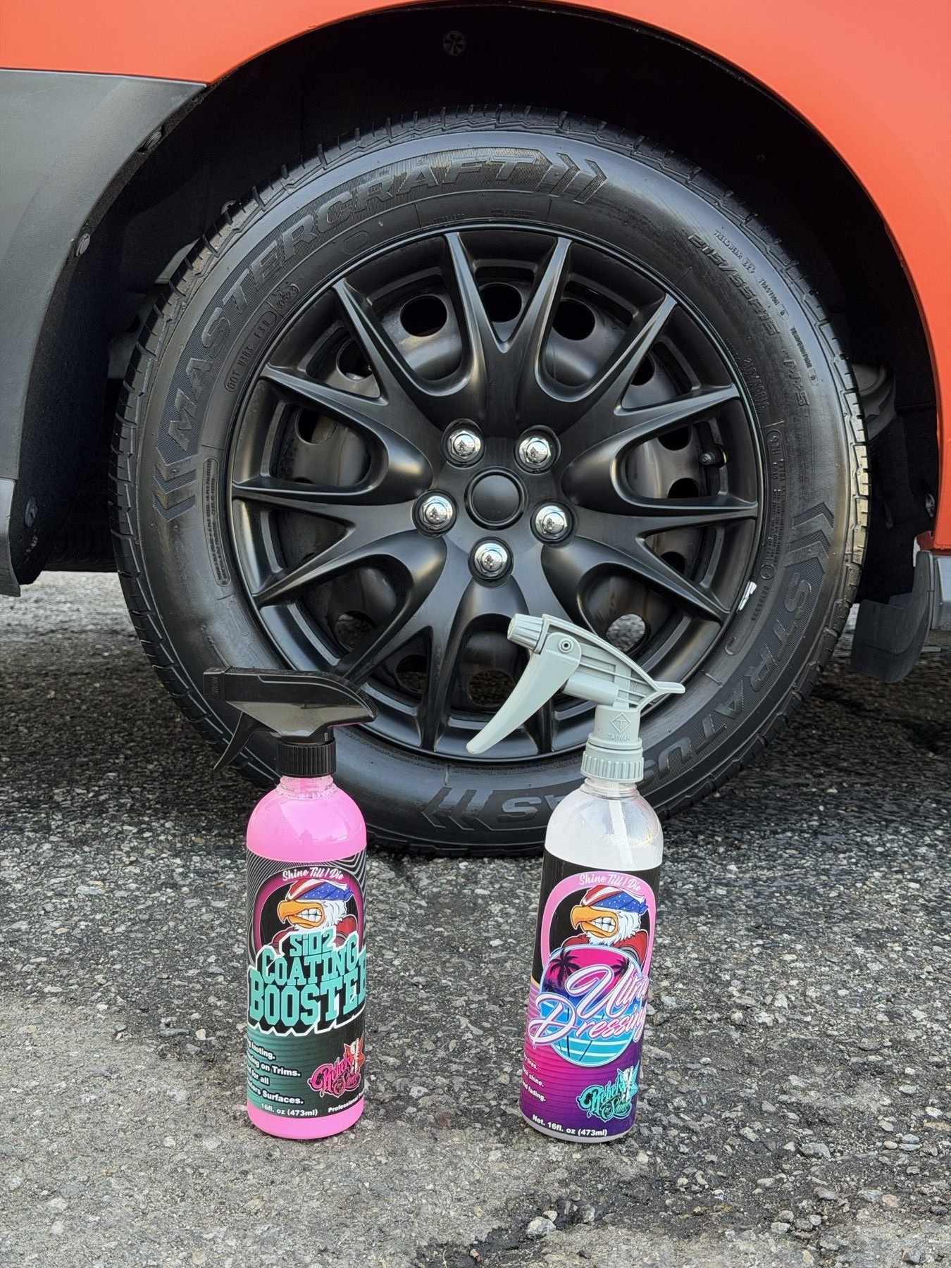 Wheel dressing bottles next to a matte-black wheel